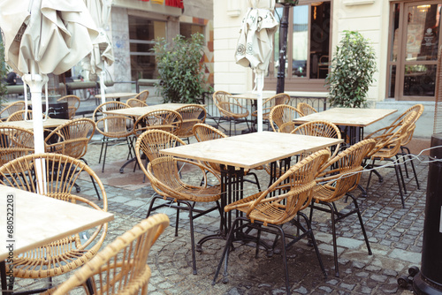 Cozy tables and chairs of outdoor cafe in european city.