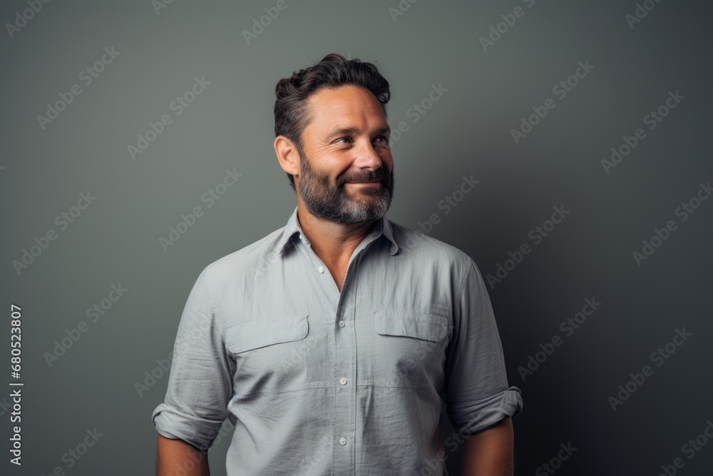 Portrait of a satisfied man in his 40s sporting a breathable hiking shirt against a modern minimalist interior. AI Generation Portrait of a satisfied man in his 40s sporting a breathable hiking shirt against a modern minimalist interior. AI Generation
