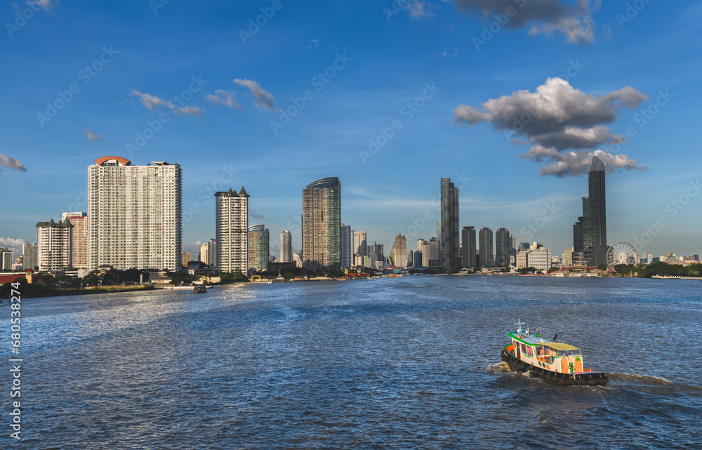 View of the buildings with a river in the foreground of the city of Bangkok