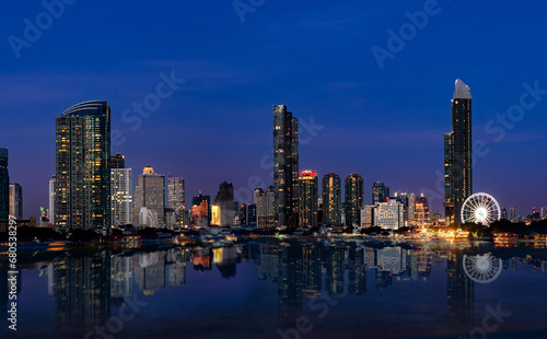 View of the buildings with a river in the foreground of the city of Bangkok
