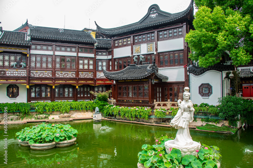 Shanghai China 11th Jun 2023: the building and lotus pond in City God Temple of Shanghai, a large commercial district that hosts an array of shops, restaurants, teahouses.