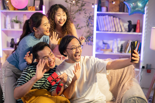 Happy friends enjoying time together and making a selfie.Christmas party with Asian people 2023 at home.