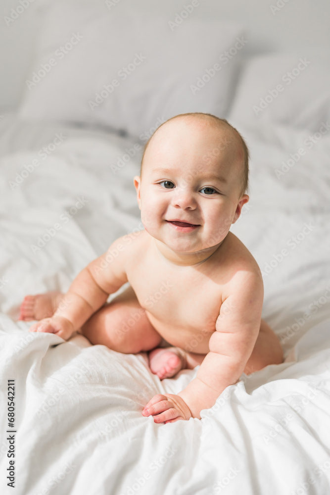 Happy baby lying on bed laughing. Generation alpha and gen alpha Happy baby lying on bed laughing. Generation alpha and gen alpha