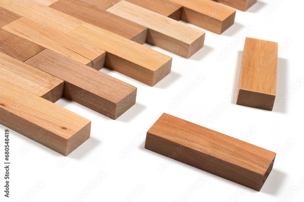 stacked wooden blocks on white. wood game jenga close up. wooden background close up. stacked wooden blocks on white. wood game jenga close up. wooden background close up.