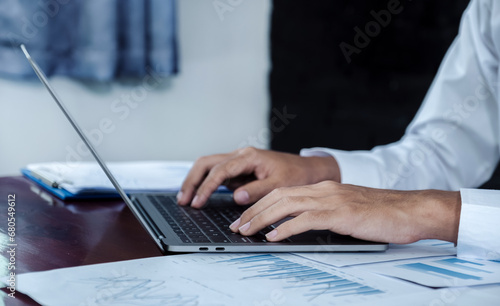 Businessmen bookkeeper use laptop analysis the graph for Setting challenging business goals and ready to achieve target at home office