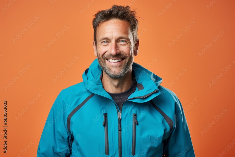 Portrait of a smiling man in his 40s wearing a windproof softshell against a pastel or soft colors background. AI Generation Portrait of a smiling man in his 40s wearing a windproof softshell against a pastel or soft colors background. AI Generation