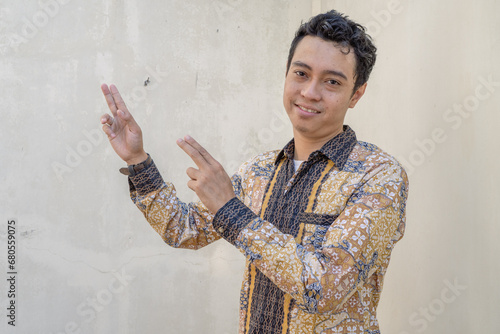 Young Indonesian wear batik traditional culture of Indonesia with click link thumbnail The photo is suitable to use for daily advertising and traditional culture content media. photo
