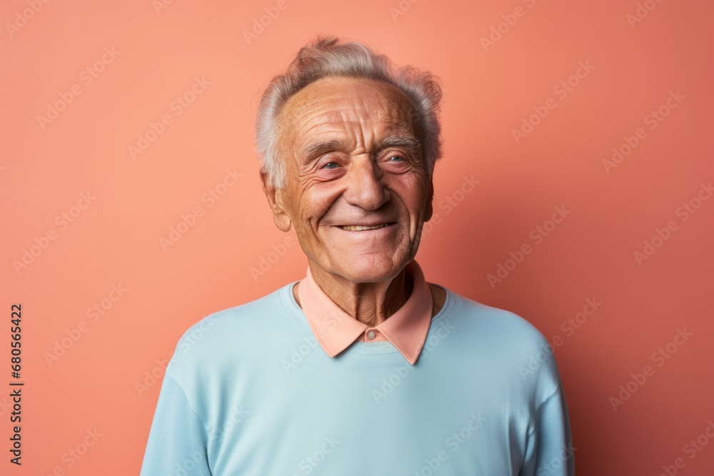 Portrait of a smiling man in his 80s sporting a technical climbing shirt against a solid pastel color wall. AI Generation Portrait of a smiling man in his 80s sporting a technical climbing shirt against a solid pastel color wall. AI Generation