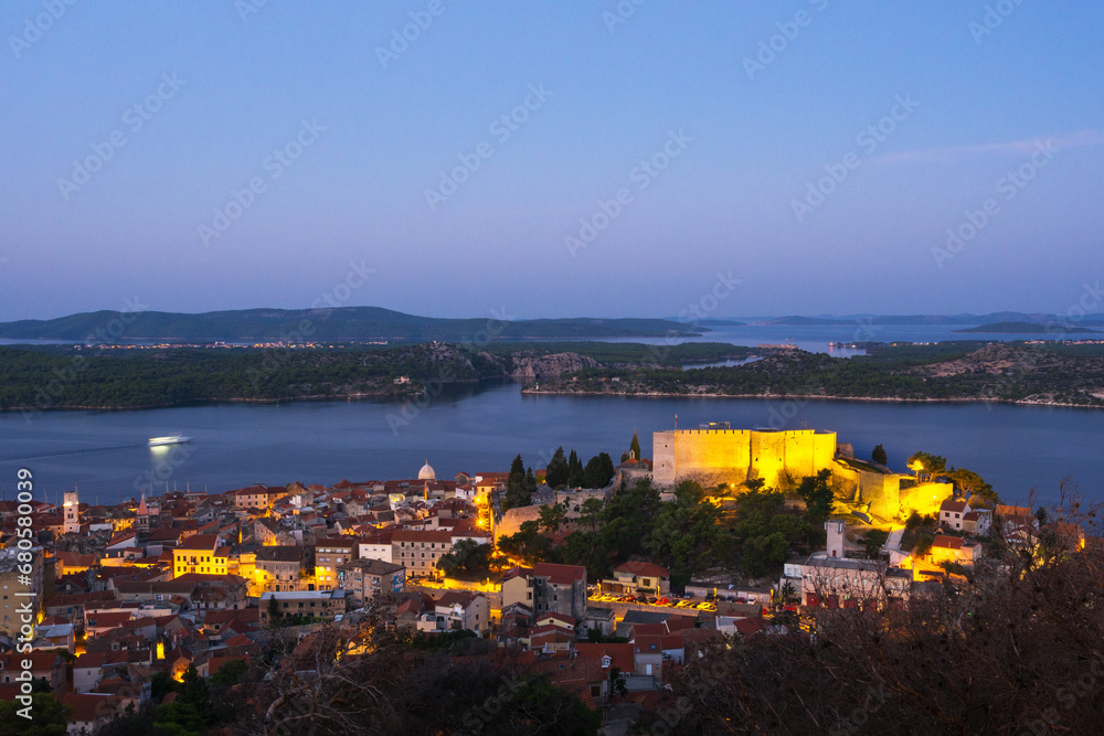 Illuminated St. Michael's Fortress and city buildings at dusk, Sibenik, Sibenik-Knin, Croatia