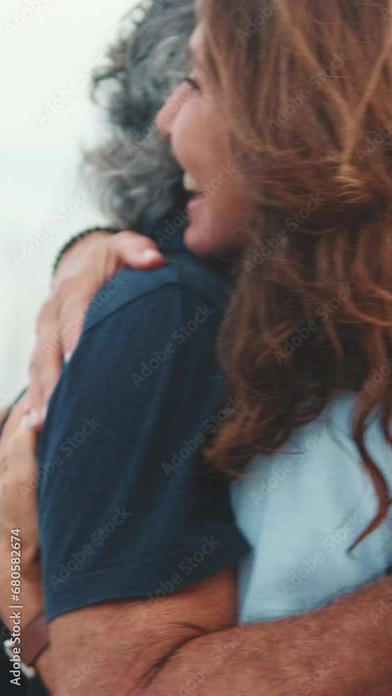 An elderly aged couple hugging joing meeting in marina An elderly aged couple hugging joing meeting in marina