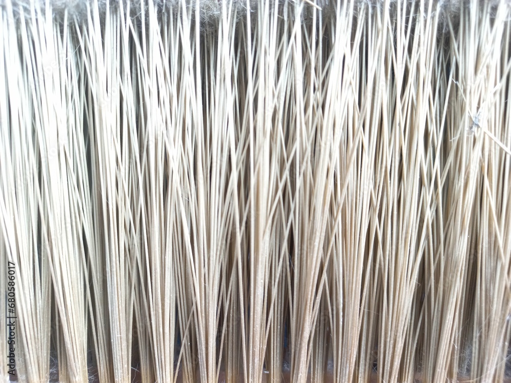 Vertical stripes pattern and texture of brown broom plastic bristles. Close up. Concept photo for background, texture or pattern object. Vertical stripes pattern and texture of brown broom plastic bristles. Close up. Concept photo for background, texture or pattern object.
