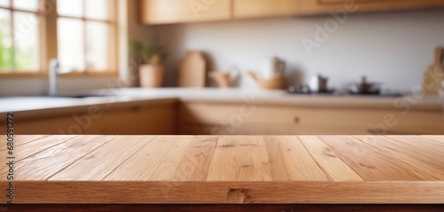 Wooden table on blurred kitchen bench background. Empty wooden table and blurred kitchen background for display or montage your products photo