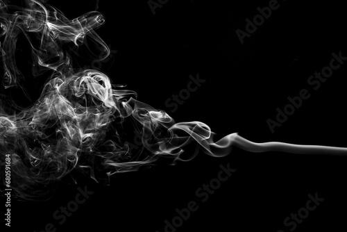 Incense sticks smoke on black background, black and white monochromatic studio picture. Abstract vision