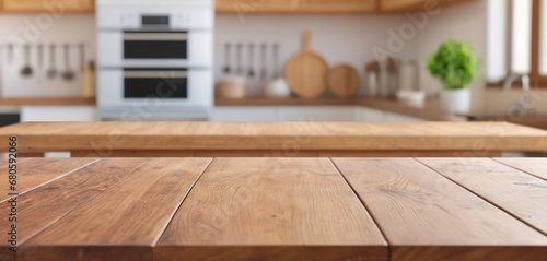 Wooden table on blurred kitchen bench background. Empty wooden table and blurred kitchen background for display or montage your products