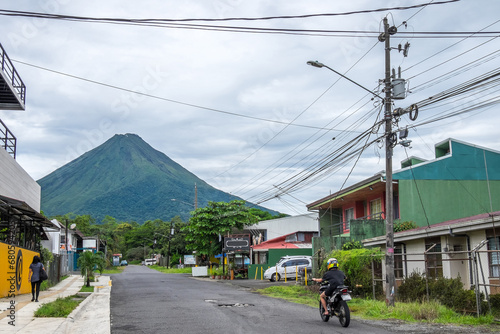 Pueblo de La Fortuna y vista del volcán Arenal en la provincia de Alajuela en Costa Rica photo