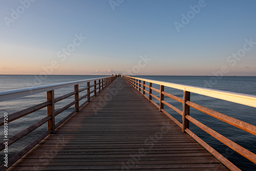 Ahlbeck Pier on the German island of Usedom jutting out into the Baltic Sea  illuminated by the light of the setting sun