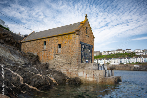Seascape of lifeboat house in tranquil cornish harbour