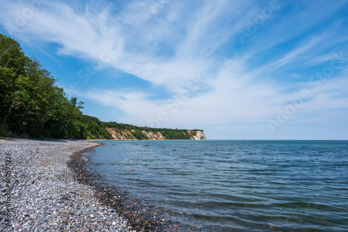 Fototapeta Naklejka Na Ścianę i Meble -  Gravel beach on the Baltic Sea coast on the German island of Rügen, facing towards the cliffs at Cape Arkona