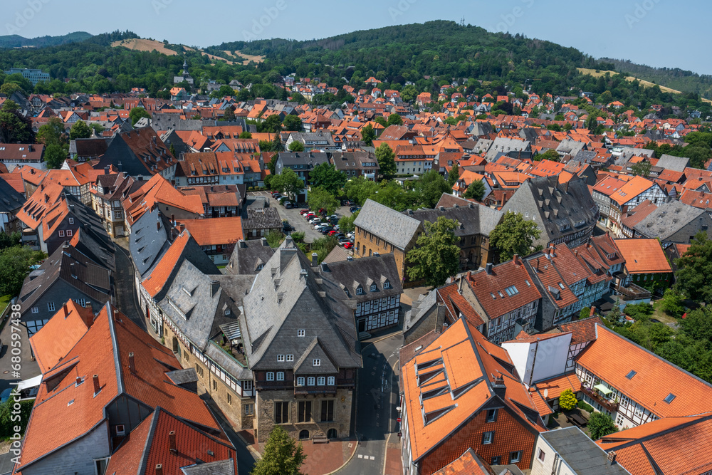 Summertime view over the red rooftops of the UNESCO historic town of Goslar towards the hills of the Harz in northern Germany