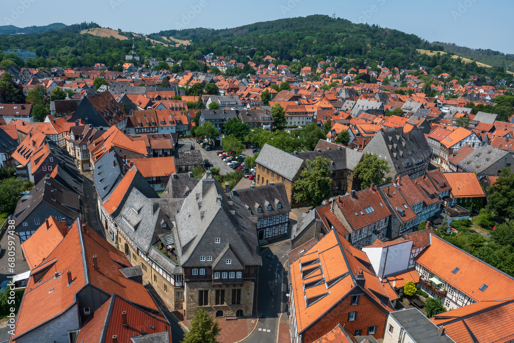 Summertime view over the red rooftops of the UNESCO historic town of Goslar towards the hills of the Harz in northern Germany Summertime view over the red rooftops of the UNESCO historic town of Goslar towards the hills of the Harz in northern Germany