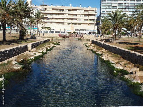 ría de comaruga desembocando en el mar mediterráneo, aguas cristalinas y con propiedades medicinales que son aprovechadas por los paseantes, tarragona, cataluña, españa, europa photo