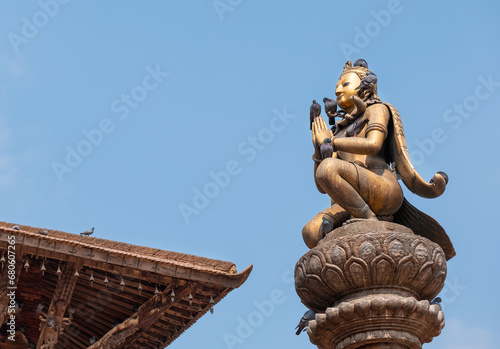 Real art masterpiece in old temple decorations statue of Garuda god of birds on Patan Durbar Square royal medieval palace and UNESCO World Heritage Site. Lalitpur, Nepal. photo