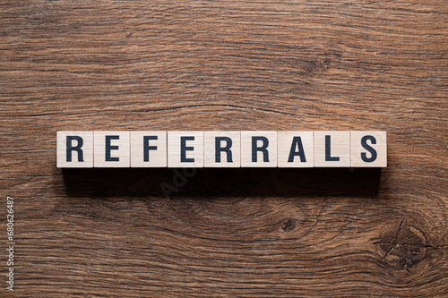 Referrals - word concept on building blocks, text