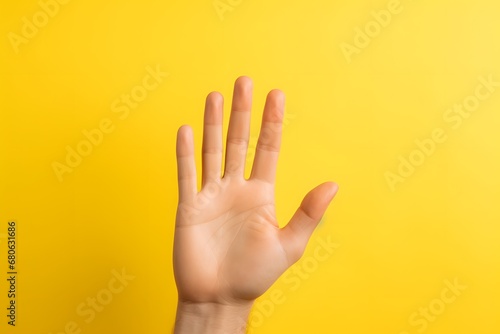 a close up of a person's hand on a yellow background Generative AI