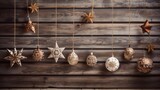  a group of christmas ornaments hanging from strings on a wooden wall with stars and snowflakes hanging off of the sides of the strings and on the sides of the sides of the strings.