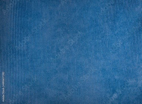 Blue velvet fabric used for sewing clothes for store. Textile material of velours texture as background. Catalog photo of samples. 