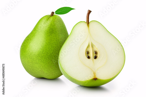 A solitary green pear, divided in two, is sharply in focus on a white backdrop.