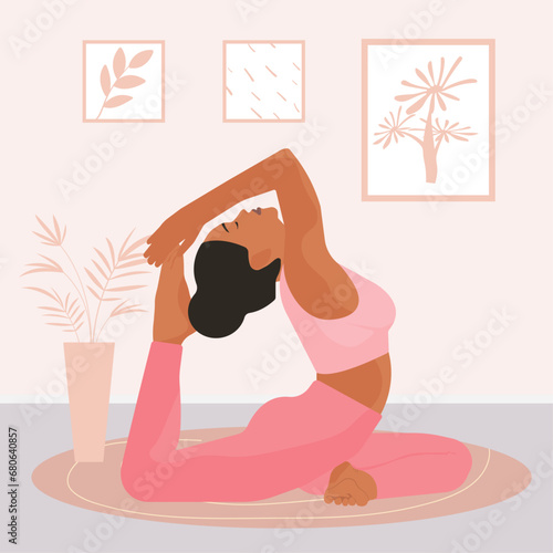 Young girl in pink clothes doing yoga in the apartment