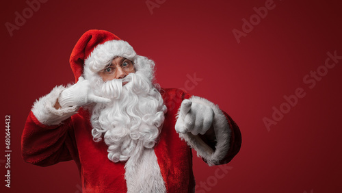 Santa Claus making a call me gesture, inviting holiday conversations