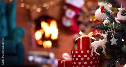 Christmas tree decorated with beautiful toys and gifts near the fireplace with fire photo