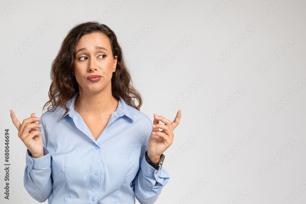 Confused doubt millennial european lady in formal wear hold with fingers copy space, show size Confused doubt millennial european lady in formal wear hold with fingers copy space, show size