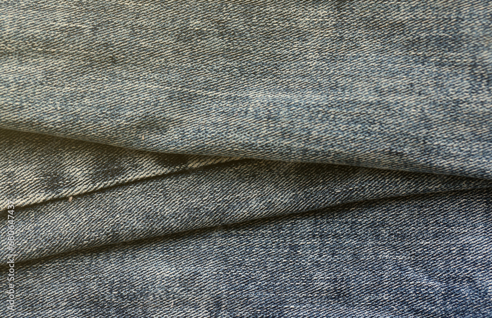 Detailed abstract texture of dark blue denim cloth. Background image of old used denim trousers fabric close up Detailed abstract texture of dark blue denim cloth. Background image of old used denim trousers fabric close up