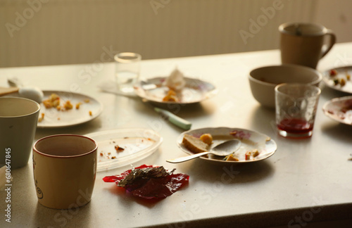 Empty dirty plates with spoons and forks on the table after meal. Banquet ending concept. Unwashed dishes ready to cleaning