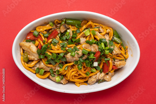 Asian cuisine. Noodles with chicken. Close up