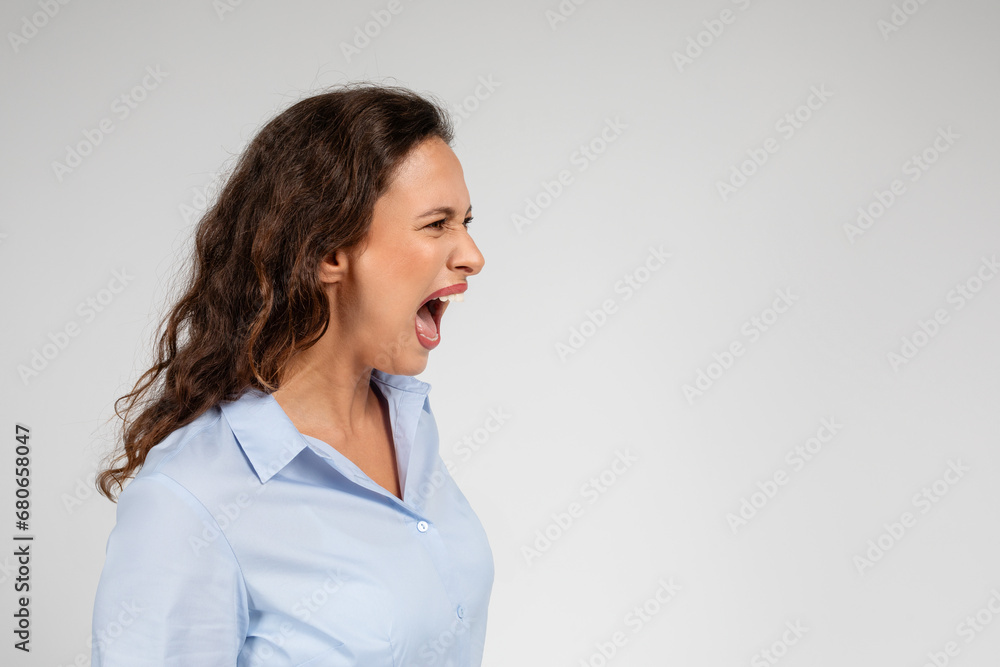 Angry despaired sad young caucasian businesswoman in formal wear screams, freaking out, cry Angry despaired sad young caucasian businesswoman in formal wear screams, freaking out, cry