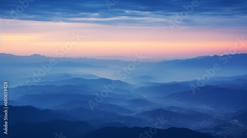 aerial picture of twilight sunset, haze in valley under a clear dark blue sky, copy space, 16:9 © Christian