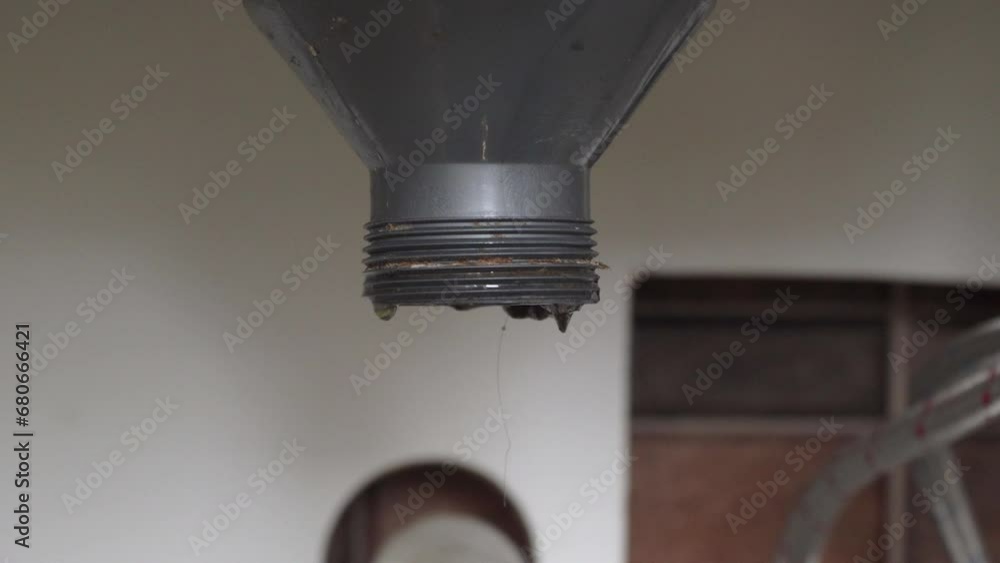 cleaning a clogged sink,a plumber cleans a clogged drain in a sink with a wire cleaning a clogged sink,a plumber cleans a clogged drain in a sink with a wire