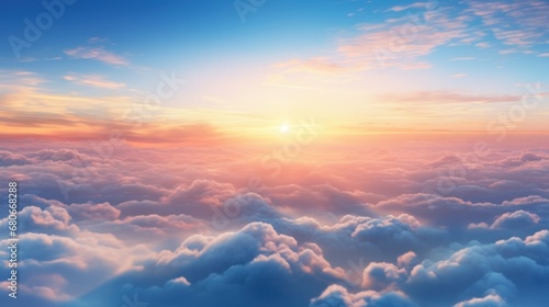  the sun shines brightly above the clouds in this view of a blue sky with pink and yellow hues. © Oleg