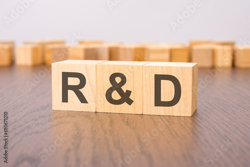 R and D text on wooden blocks. wooden background. foreground