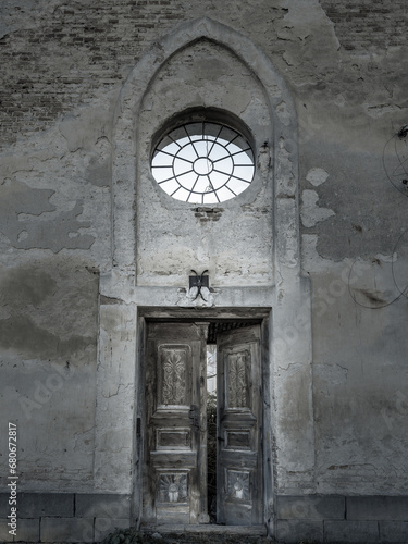 view to the stained glass and old doors of old abandoned cathedral in Ukraine