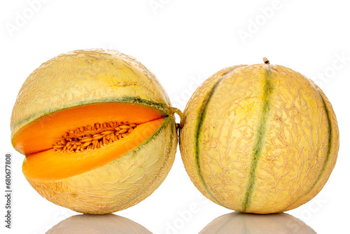Two whole ripe melons, close-up, isolated on white.