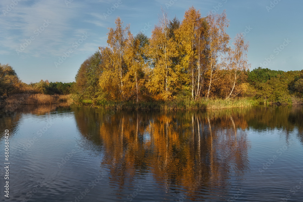 Autumn pond, reflection of trees in the water in autumn colors. Gdansk, Poland