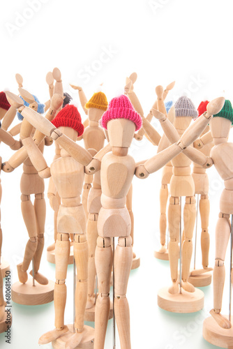 Crowd wooden mannequins with winter hat photo