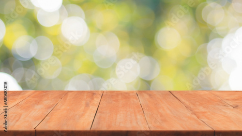 Empty wooden table over blur green bokeh background, outside picknick, product display montage