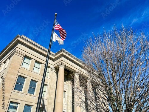 Exterior Views of the Appellate Court of the State of Illinois Fourth District Building in Springfield, Illinois, USA. American and State of Illinois Flags fly in the forefront of view. photo