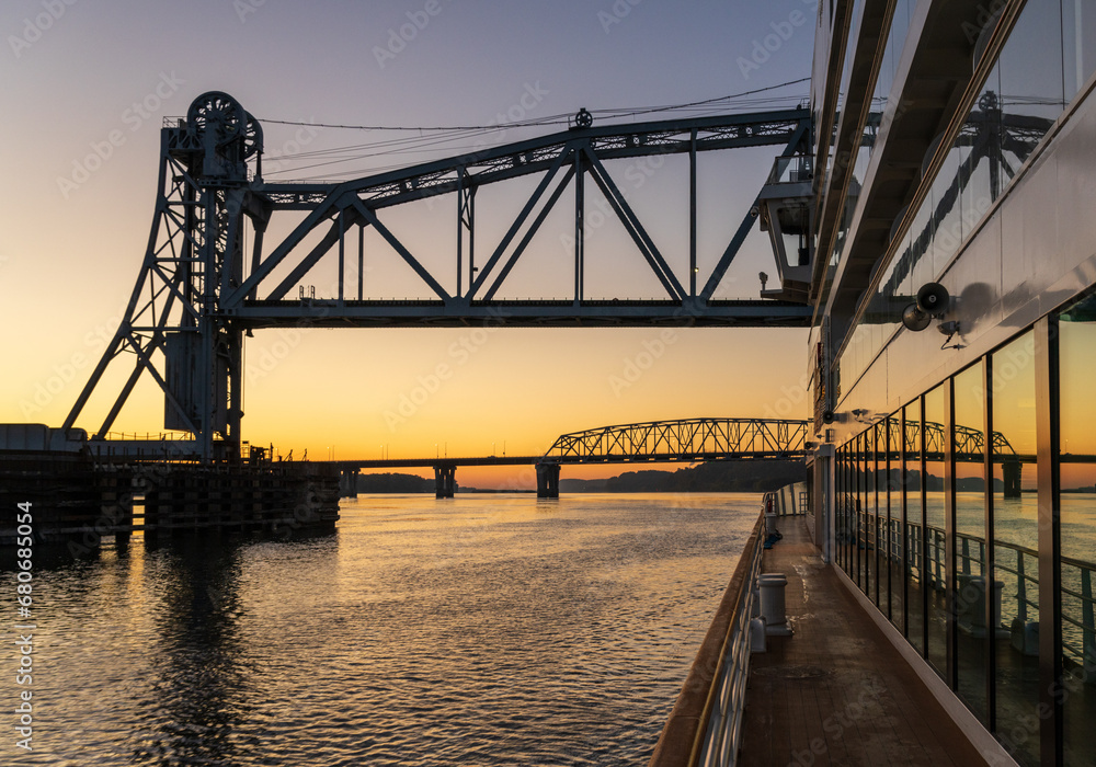 Mississippi river cruise boat sails under Wabash Railroad bridge towards Mark Twain Memorial road bridge near Hannibal, Missouri